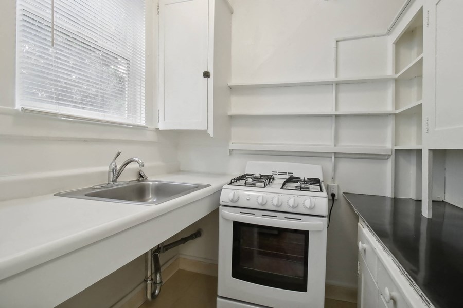 the kitchen of a home with a stove and a sink